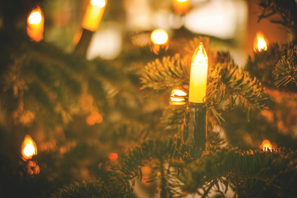 Close-up of warm glowing lights on a Christmas tree, creating a festive atmosphere.